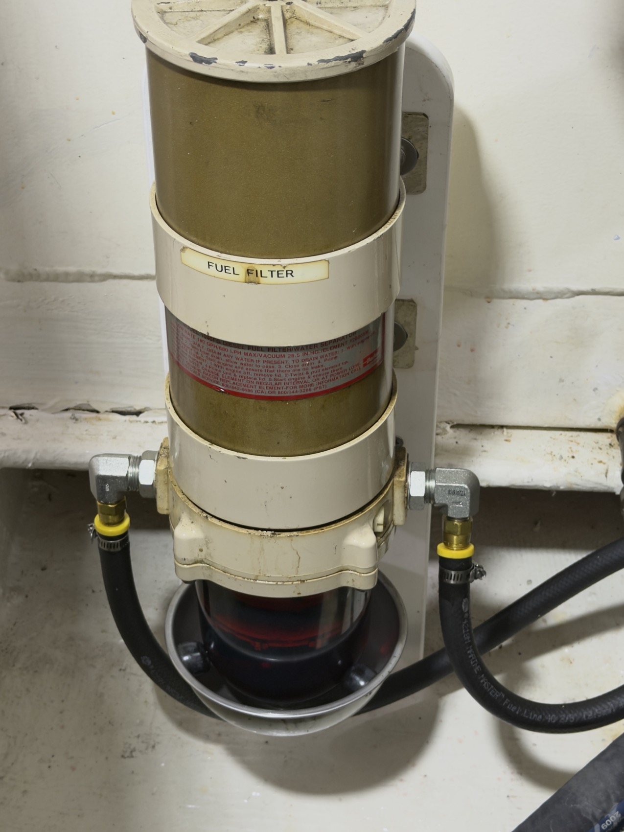 A diesel fuel filter and water separator in a boat's engine bay — the photo that starts the diagnosis